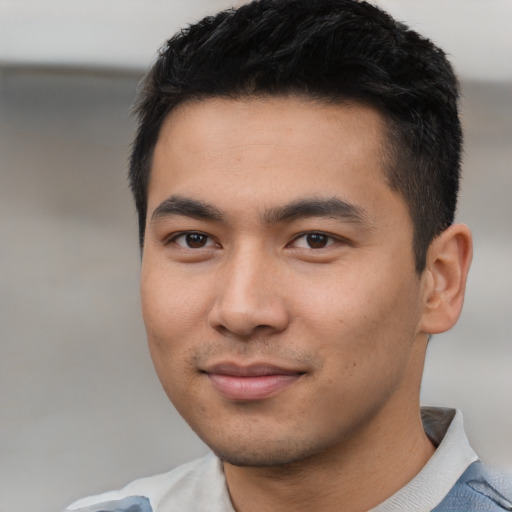 Joyful asian young-adult male with short  black hair and brown eyes