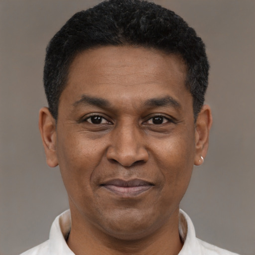 Joyful latino adult male with short  black hair and brown eyes