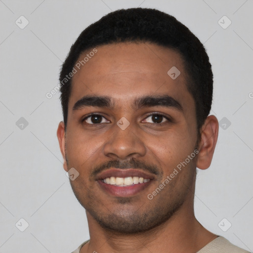 Joyful black young-adult male with short  black hair and brown eyes