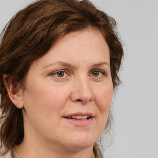 Joyful white adult female with medium  brown hair and grey eyes