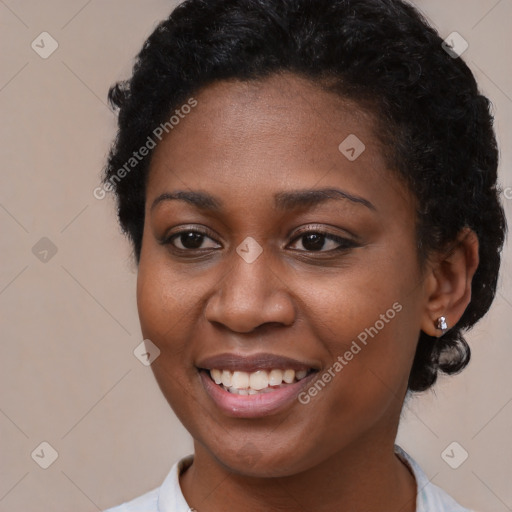 Joyful black young-adult female with short  brown hair and brown eyes