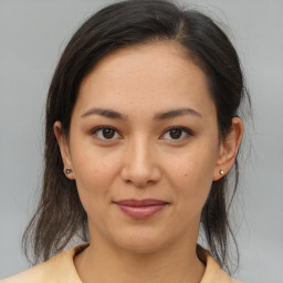 Joyful asian young-adult female with medium  brown hair and brown eyes