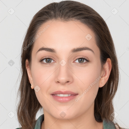 Joyful white young-adult female with long  brown hair and grey eyes