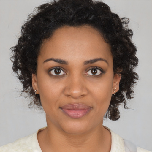 Joyful black young-adult female with medium  brown hair and brown eyes