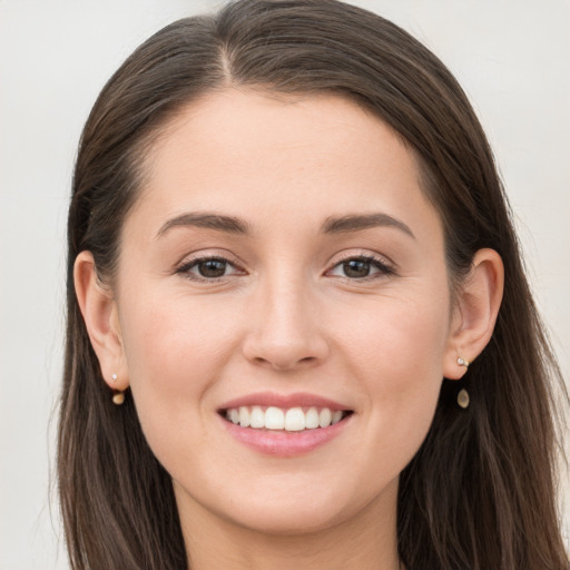 Joyful white young-adult female with long  brown hair and grey eyes