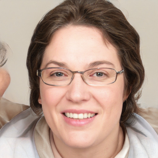 Joyful white adult female with medium  brown hair and grey eyes