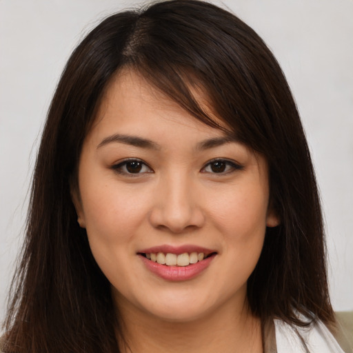 Joyful white young-adult female with long  brown hair and brown eyes