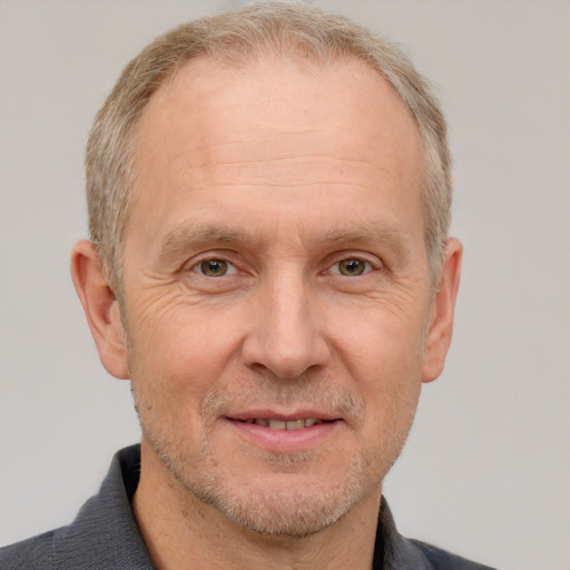 Joyful white middle-aged male with short  gray hair and brown eyes