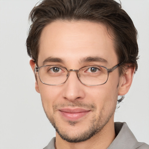 Joyful white adult male with short  brown hair and brown eyes