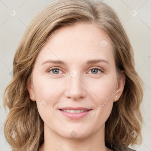 Joyful white young-adult female with medium  brown hair and blue eyes