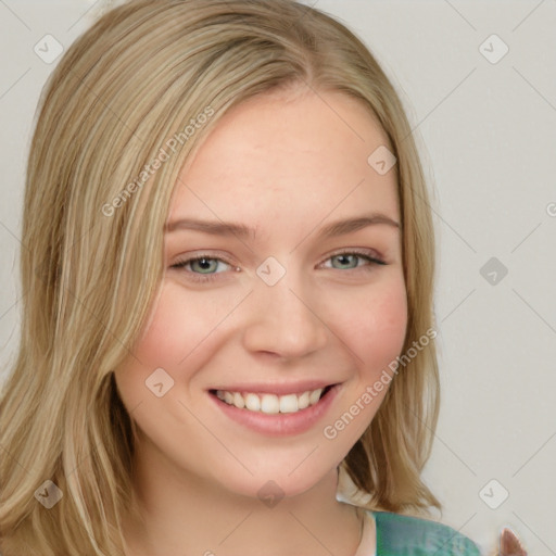 Joyful white young-adult female with long  brown hair and blue eyes