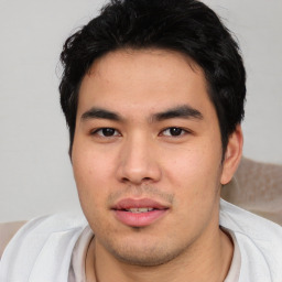 Joyful asian young-adult male with short  black hair and brown eyes