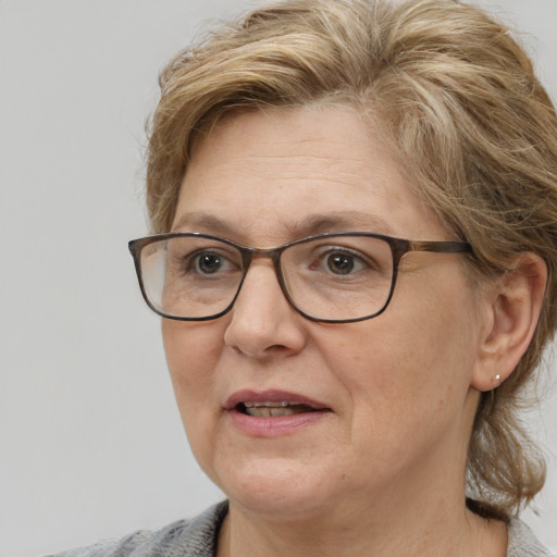 Joyful white middle-aged female with medium  brown hair and blue eyes