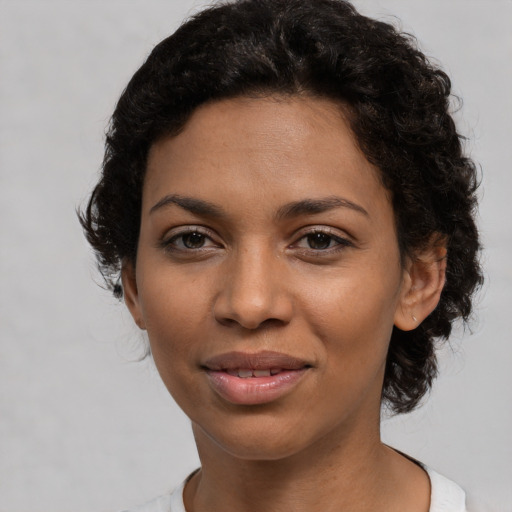 Joyful latino young-adult female with short  black hair and brown eyes