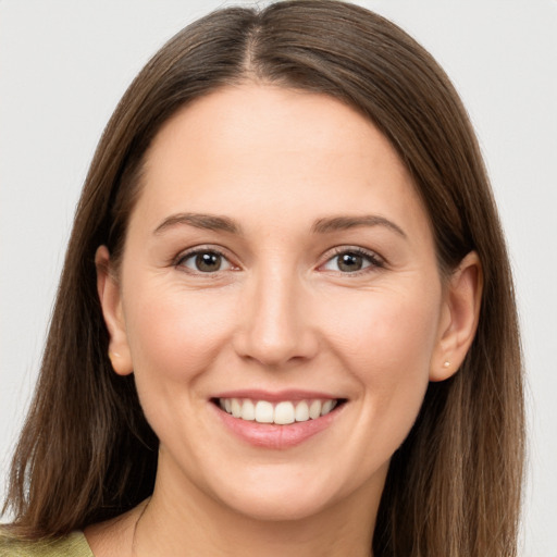 Joyful white young-adult female with long  brown hair and brown eyes