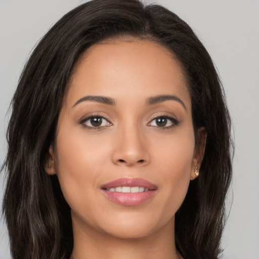 Joyful white young-adult female with long  brown hair and brown eyes