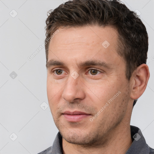 Joyful white adult male with short  brown hair and brown eyes