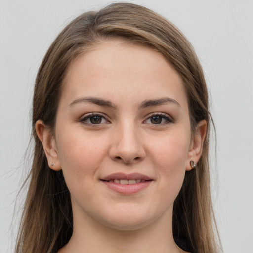 Joyful white young-adult female with long  brown hair and grey eyes