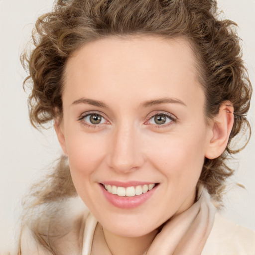 Joyful white young-adult female with medium  brown hair and blue eyes