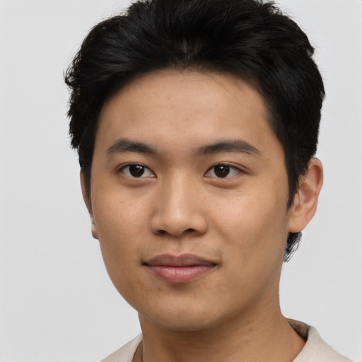 Joyful asian young-adult male with short  black hair and brown eyes
