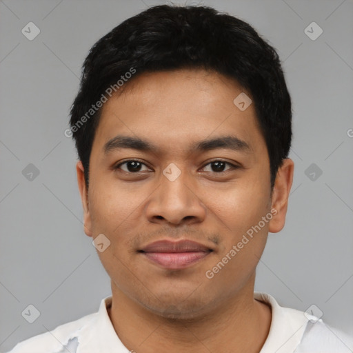 Joyful latino young-adult male with short  black hair and brown eyes