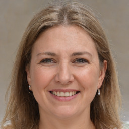 Joyful white adult female with medium  brown hair and brown eyes