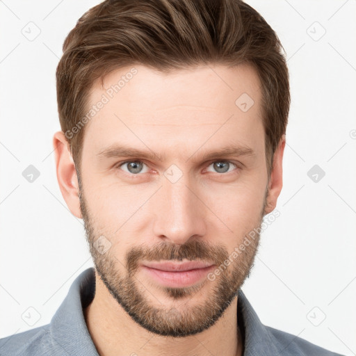 Joyful white young-adult male with short  brown hair and grey eyes