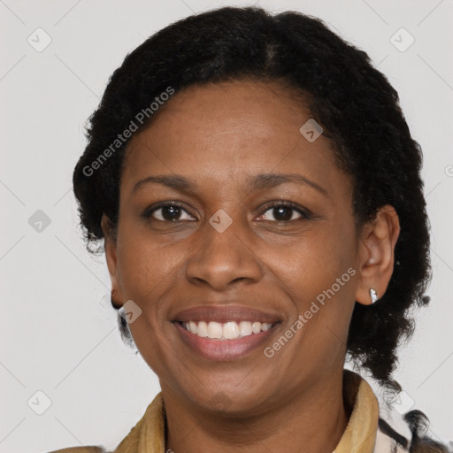 Joyful black adult female with short  brown hair and brown eyes