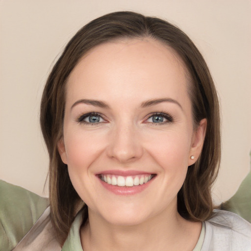 Joyful white young-adult female with medium  brown hair and grey eyes