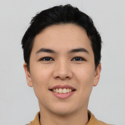 Joyful asian young-adult male with short  black hair and brown eyes