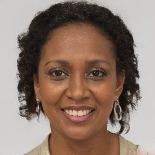 Joyful black adult female with long  brown hair and brown eyes