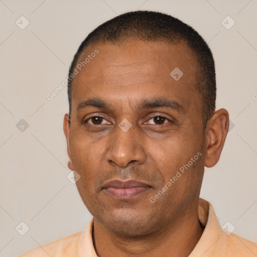 Joyful black adult male with short  black hair and brown eyes