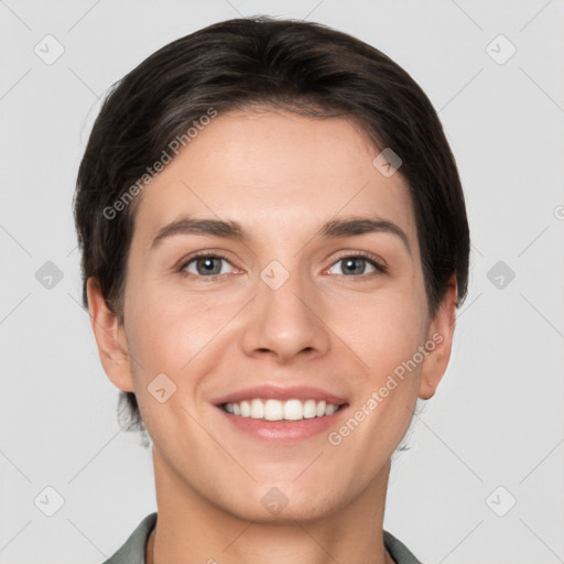 Joyful white young-adult female with short  brown hair and grey eyes