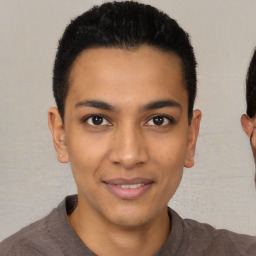 Joyful latino young-adult male with short  brown hair and brown eyes