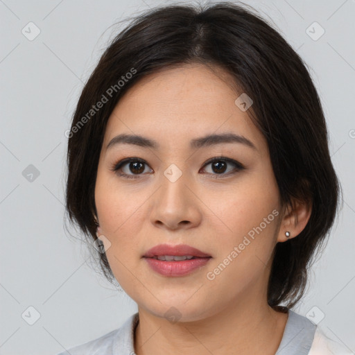 Joyful asian young-adult female with medium  brown hair and brown eyes