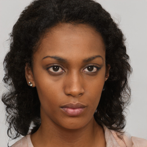Neutral black young-adult female with medium  brown hair and brown eyes