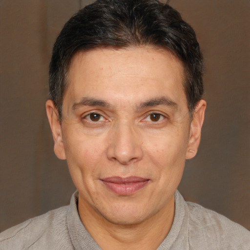 Joyful white adult male with short  brown hair and brown eyes