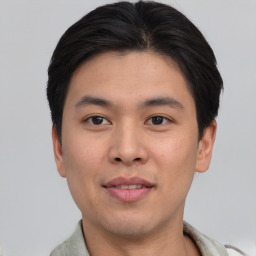 Joyful asian young-adult male with short  brown hair and brown eyes