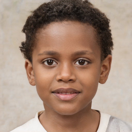 Joyful black child male with short  brown hair and brown eyes