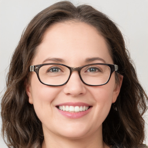 Joyful white young-adult female with medium  brown hair and blue eyes