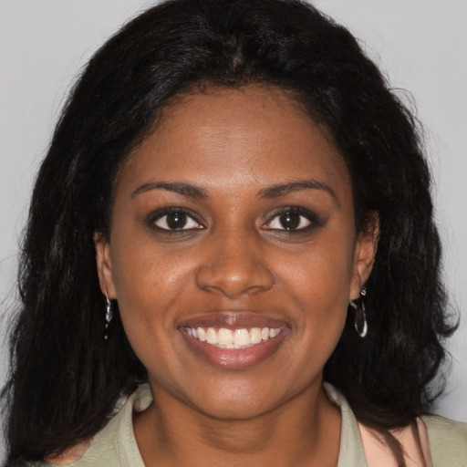 Joyful black young-adult female with medium  brown hair and brown eyes