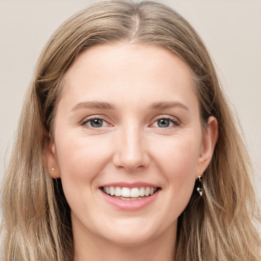 Joyful white young-adult female with long  brown hair and blue eyes