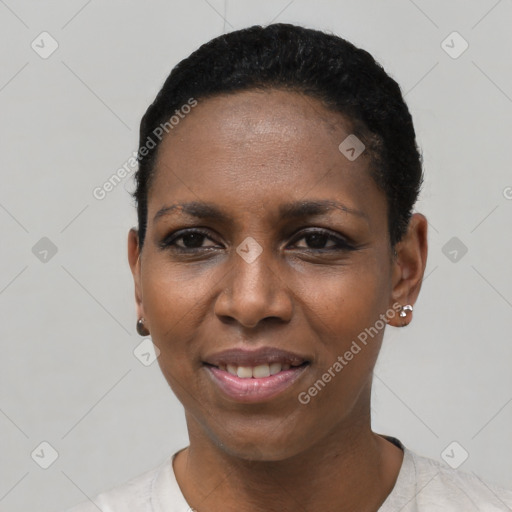 Joyful black young-adult female with short  black hair and brown eyes