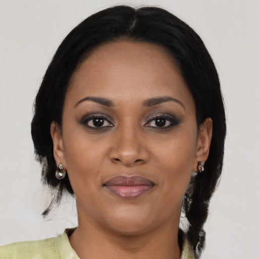 Joyful black young-adult female with medium  brown hair and brown eyes