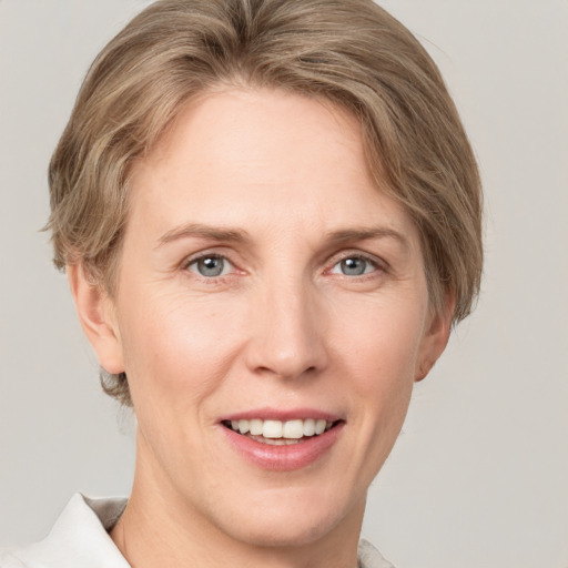 Joyful white adult female with short  brown hair and grey eyes