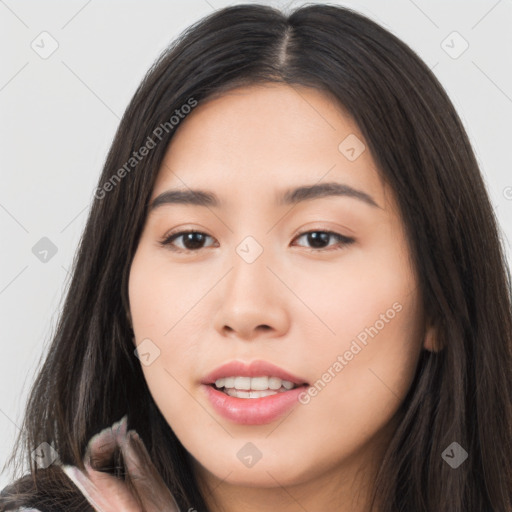 Joyful asian young-adult female with long  brown hair and brown eyes