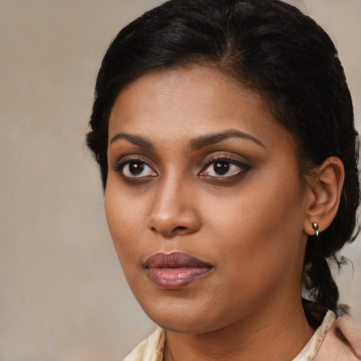 Joyful black young-adult female with medium  brown hair and brown eyes