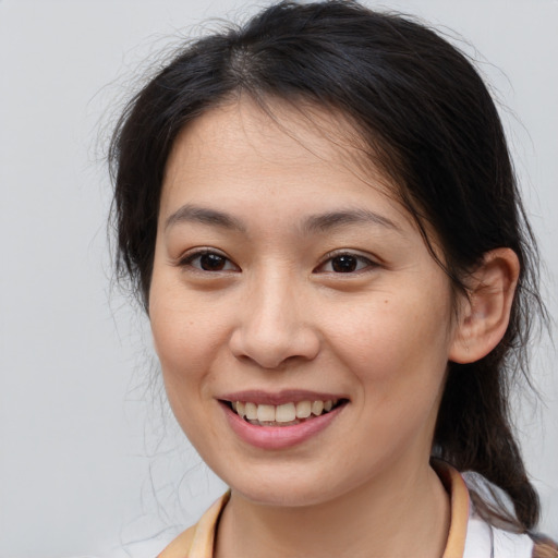 Joyful asian young-adult female with medium  brown hair and brown eyes