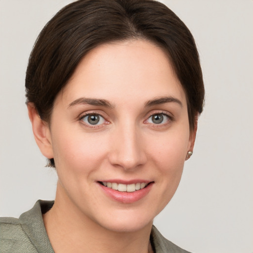 Joyful white young-adult female with short  brown hair and grey eyes