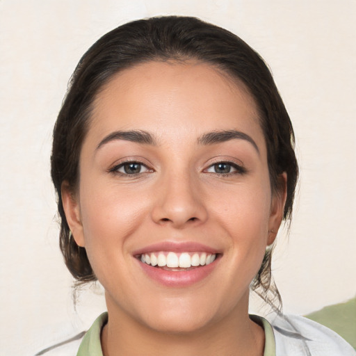 Joyful white young-adult female with medium  brown hair and brown eyes